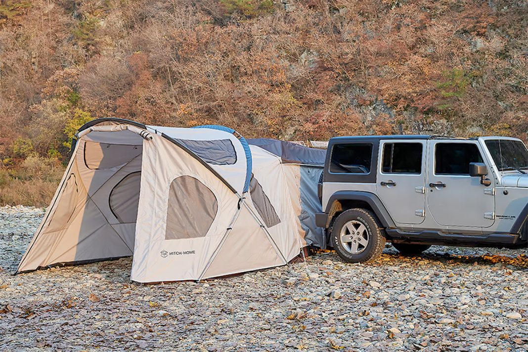 Hitchmounted tent rolls out and inflates for elevated camping