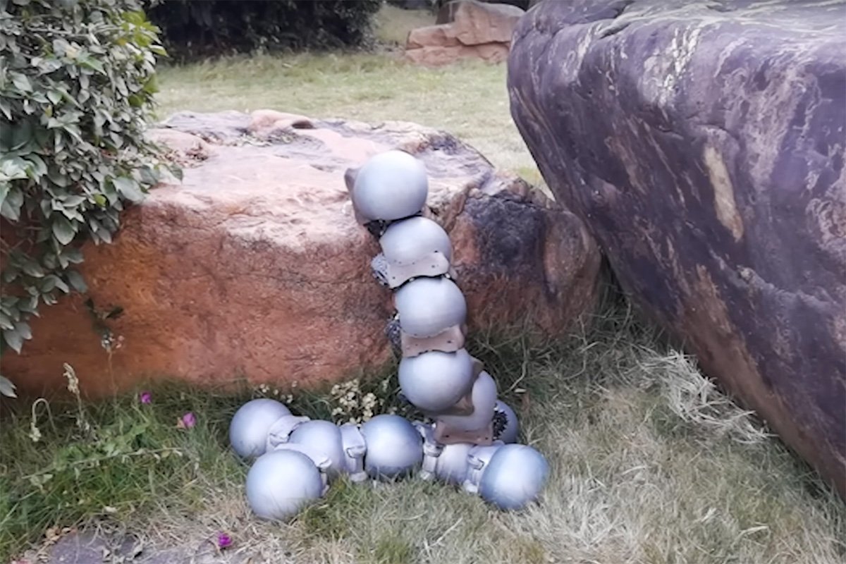 Iron-shelled Robo-snails Swarm Robotic Arm