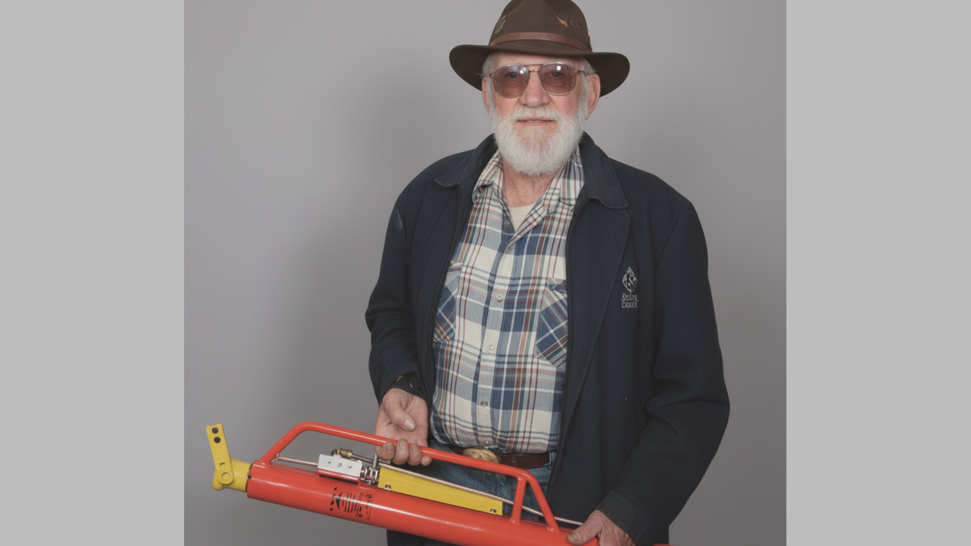 Rohrer Manufacturing founder Dan Rohrer holding an early Man Saver post driver