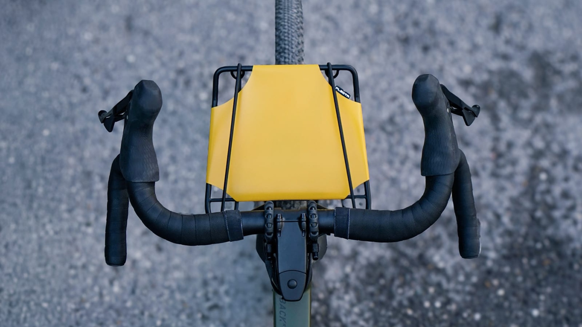 FLECTR CargoMate rack mounted above the front wheel of a drop-handlebar bicycle