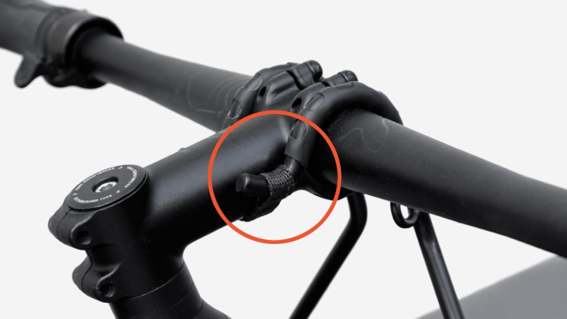 Close-up of the CargoMate rubberized hook attached to a bicycle handlebar