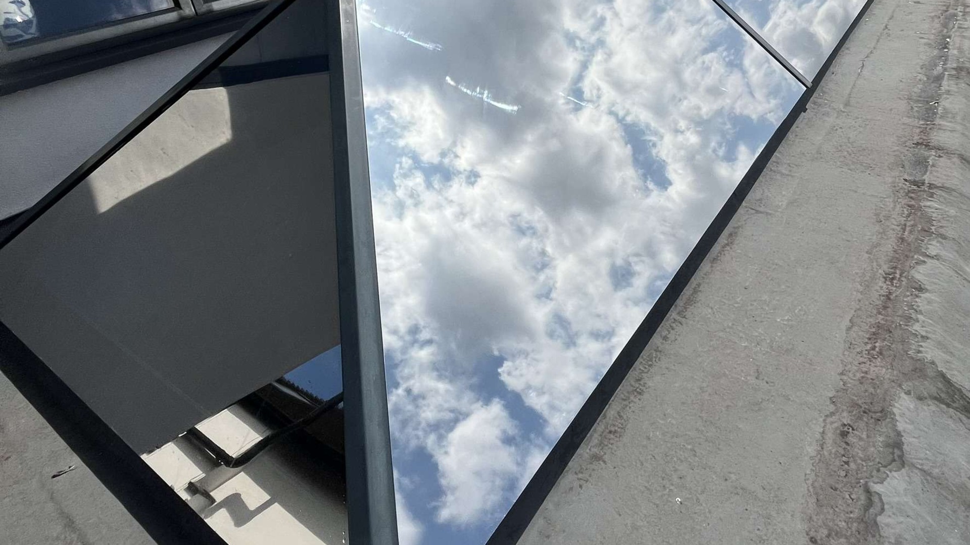 xterior Silver 20 solar-control film reflecting clouds on a glazed roof