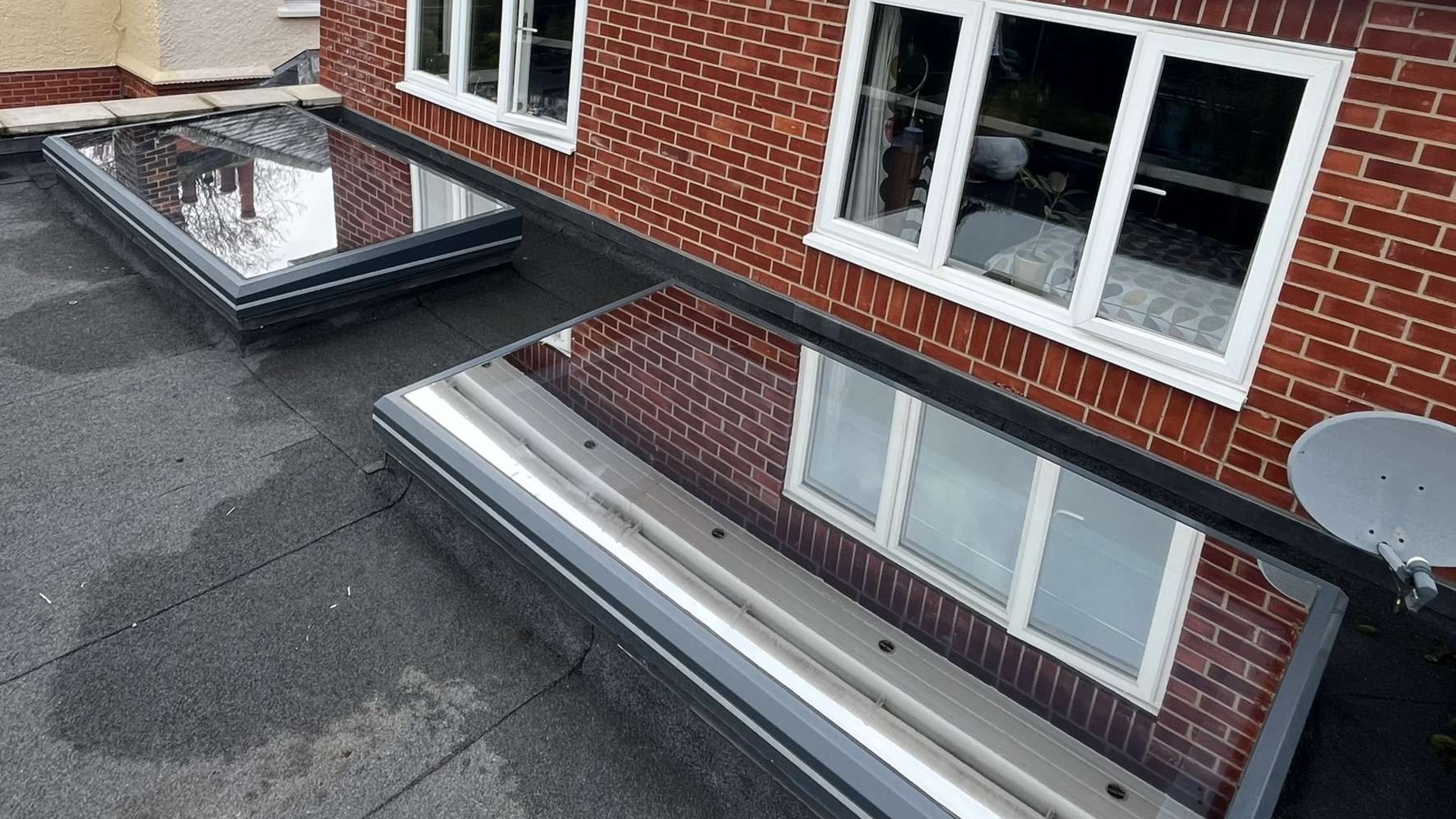 Two flat roof skylights fitted with mirrored exterior solar window film