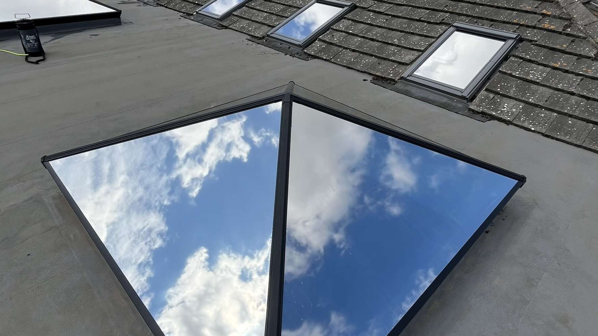 Silver 20 reflective solar film installed on roof windows and a flat skylight