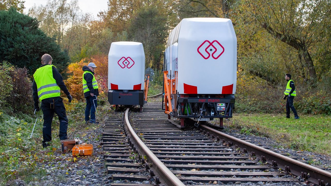 Two MONOCAB vehicles passing on opposite rails of one railway track