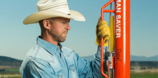 Man using a Rohrer Man Saver pneumatic post driver in a field