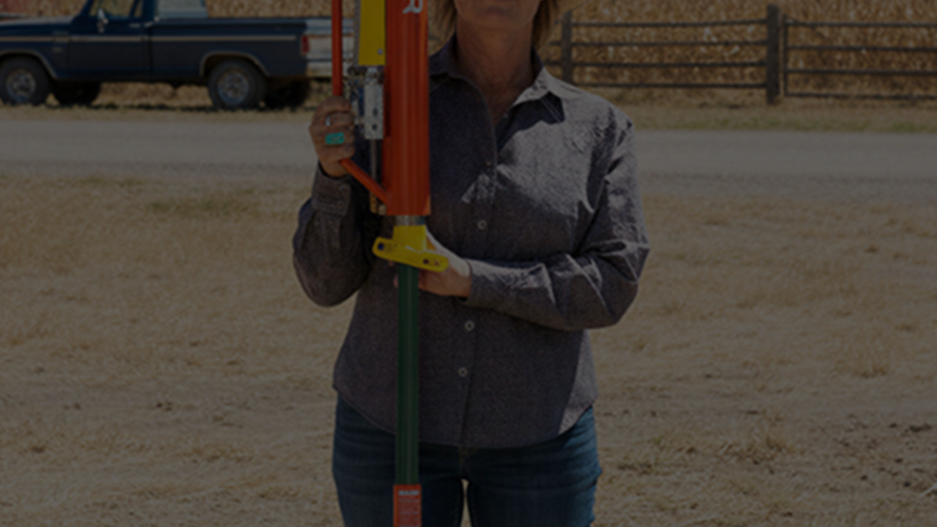 Woman operating a Rohrer Man Saver pneumatic fence post driver