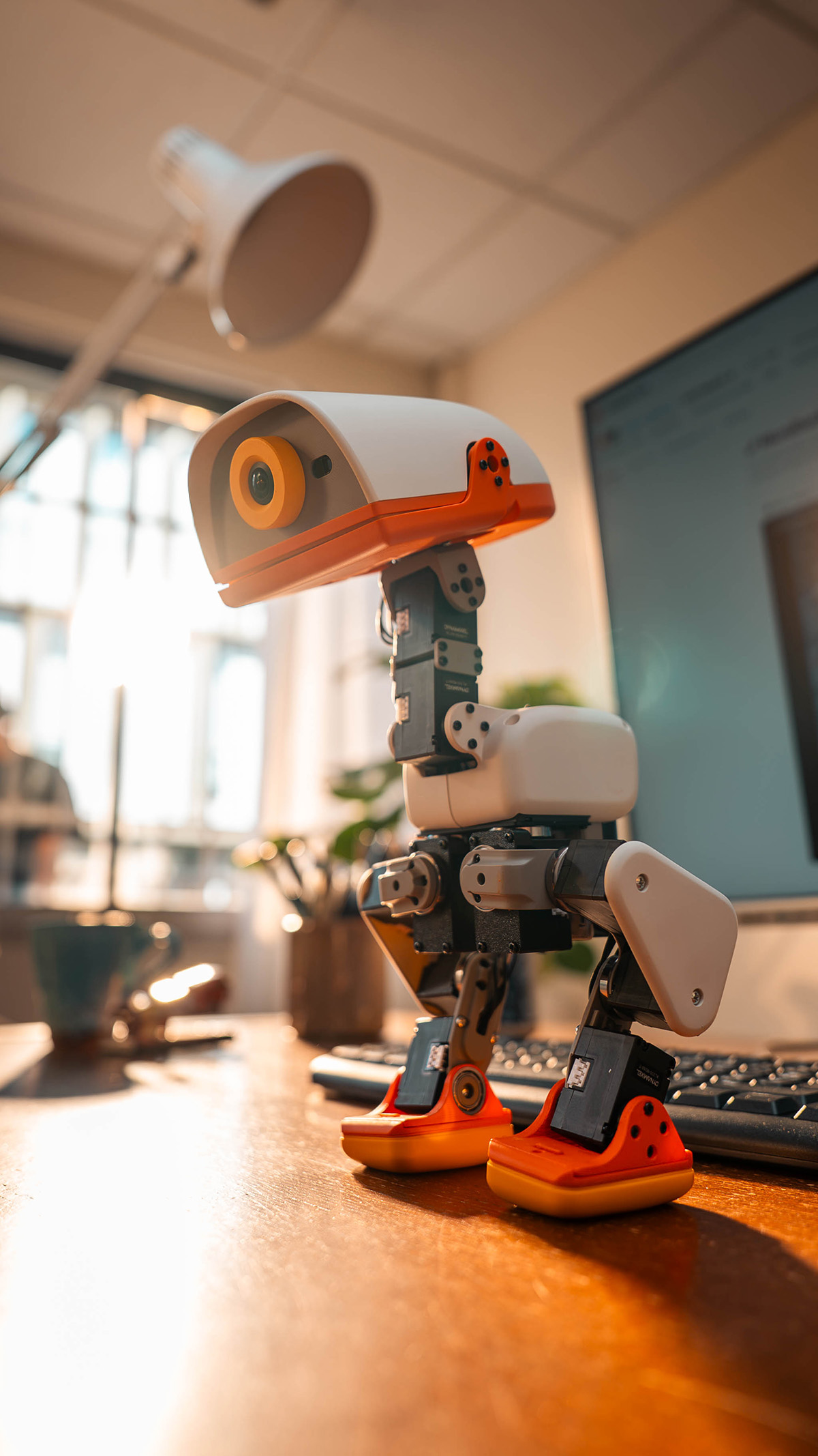 Full-length view of a MicroDuck robot standing on a tabletop