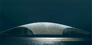 Architectural rendering of The Whale museum’s curved, whale-tail-like roof beside the ocean in Andenes, Norway.