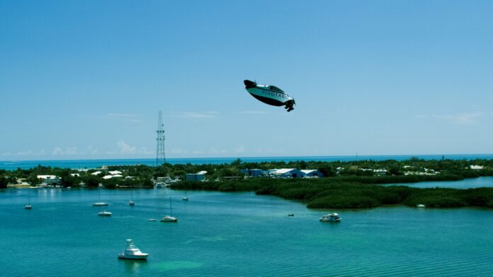Pivotal Helix electric personal aircraft flying over coastal water
