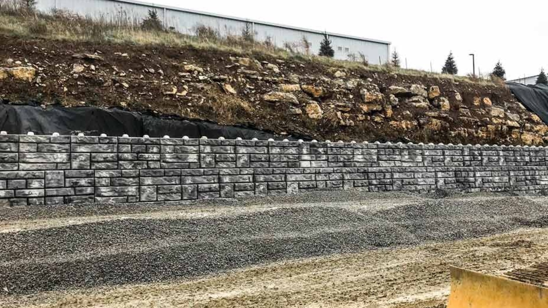 Redi-Rock XL Hollow-Core blocks used in a tall gravity retaining wall