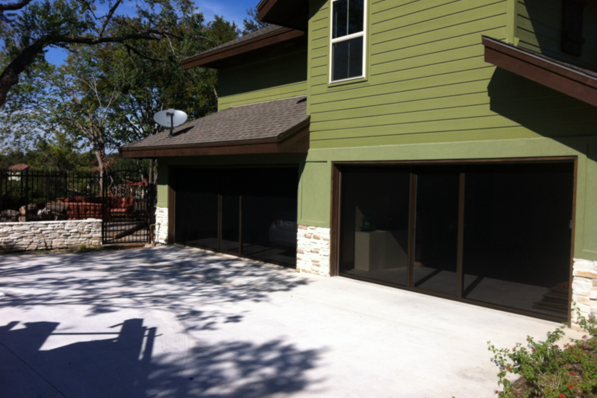 Lifestyle garage screen with a brown frame and center passage door