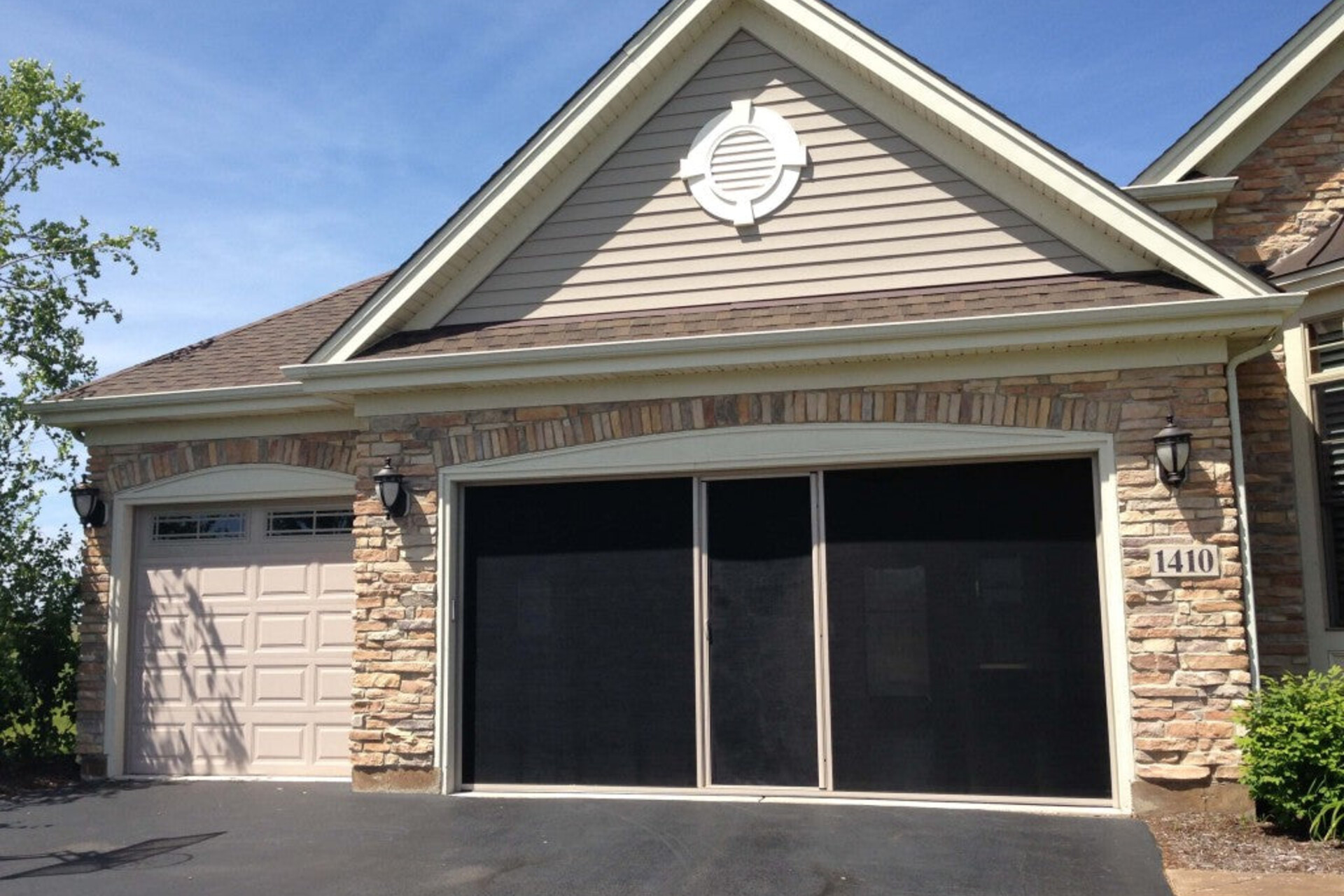 Lifestyle garage-door screen with a sandstone frame