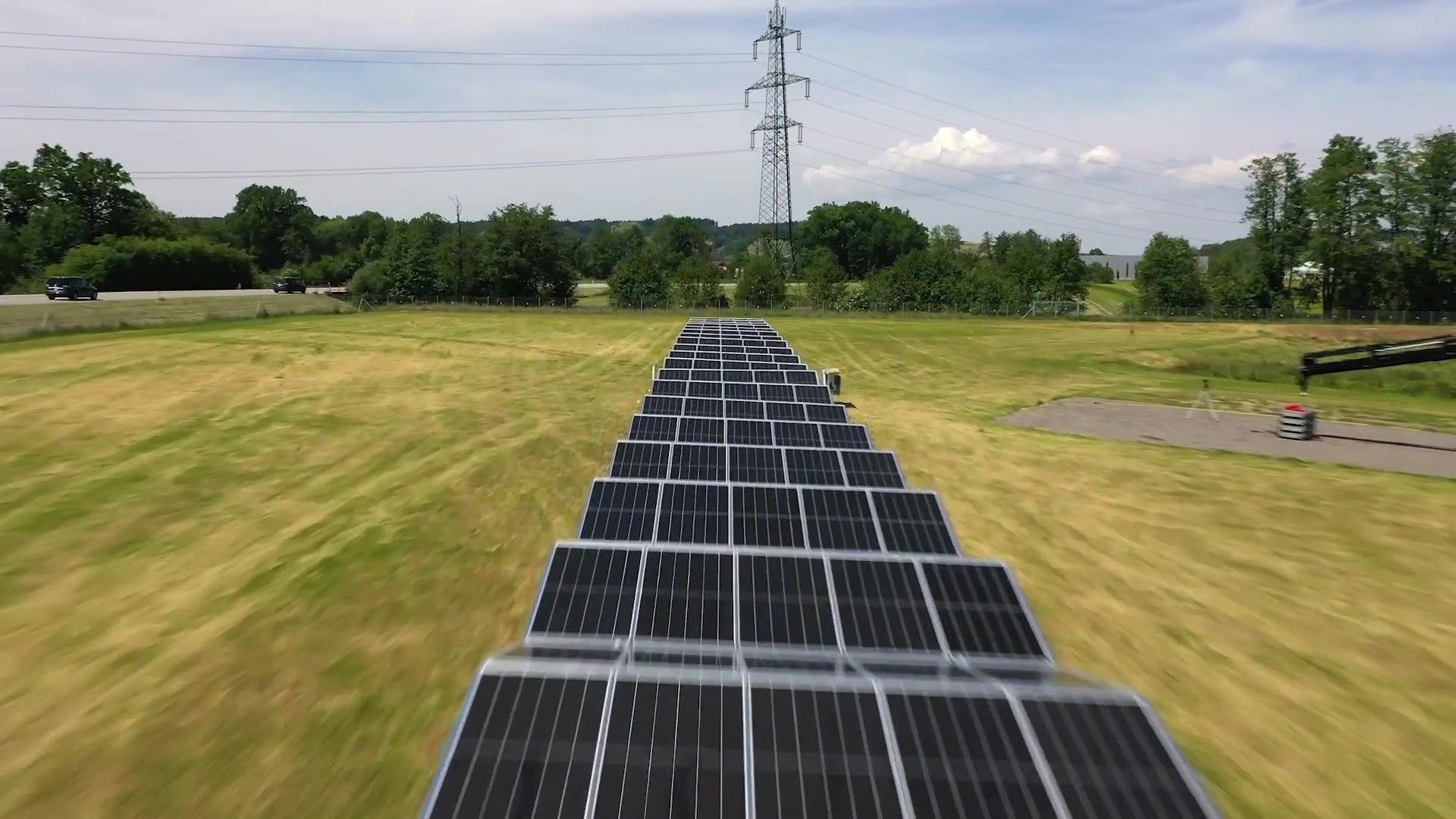 Long rows of photovoltaic panels fully deployed from a Solarcontainer
