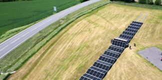 Aerial view of photovoltaic panels unfolding from the SolarCont Solarcontainer