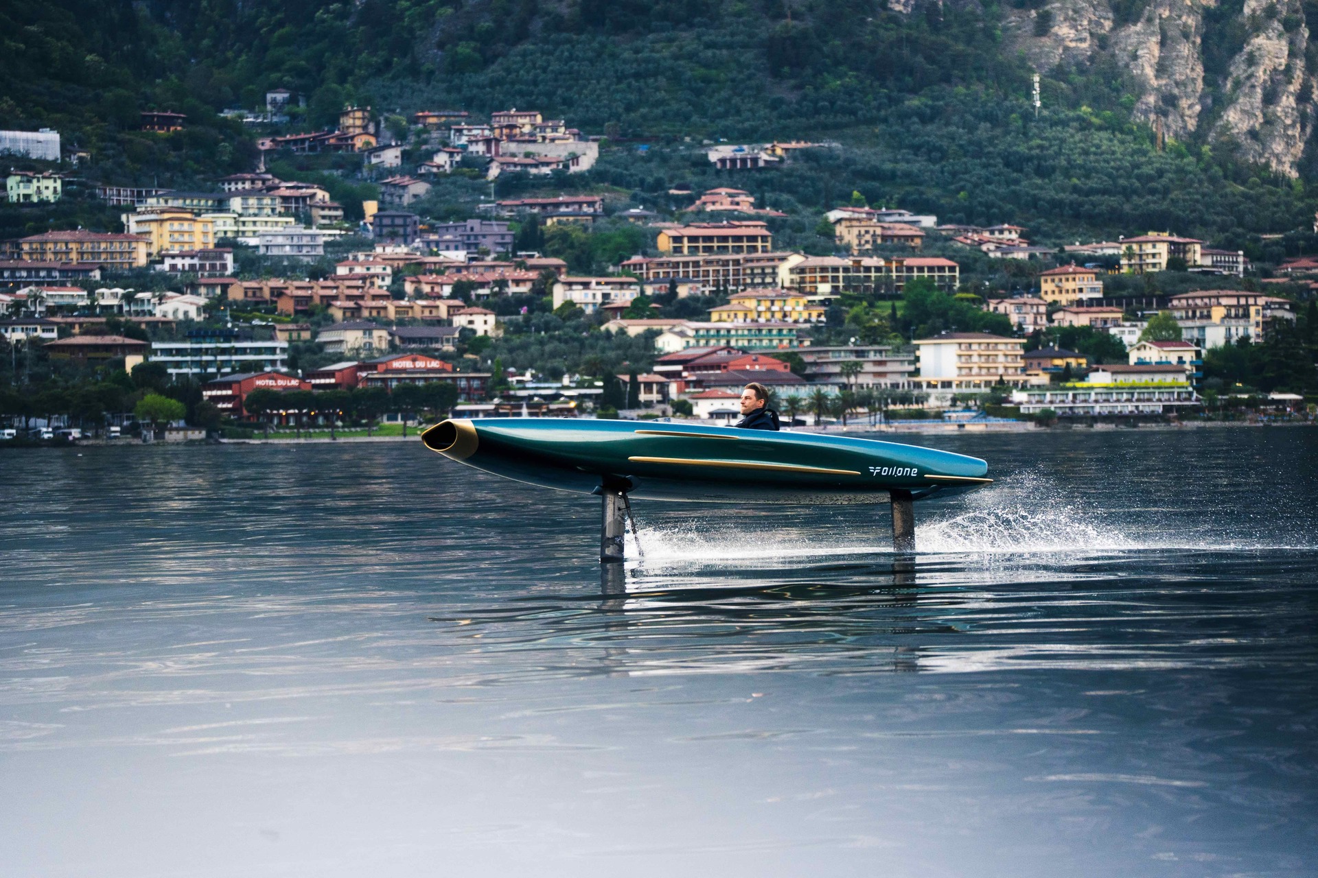 Foilone Pegasus flying across Lake Como with an Italian town behind it