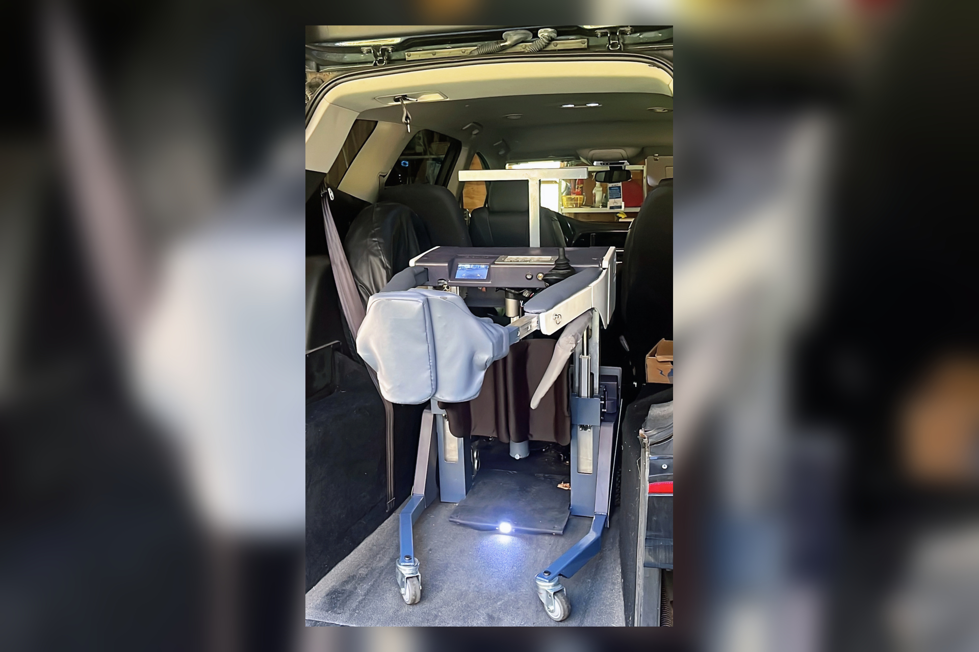 Folded REVIMO Niko transfer device loaded into the rear of a vehicle