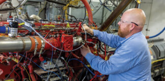 SwRI engineers working on a hydrogen-powered heavy-duty truck engine in a test cell