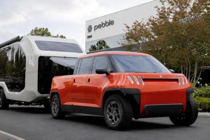 Telo MT1 compact electric pickup towing a Pebble Flow travel trailer