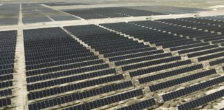 Aerial view of rows of solar panels at a large solar farm in Utah