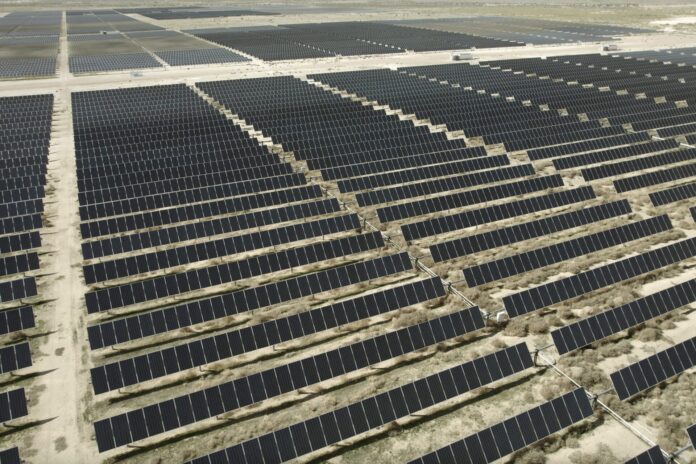Aerial view of rows of solar panels at a large solar farm in Utah