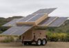 Fully deployed 123eSolar 123-STG-4 trailer with ten solar panels extended in multiple directions