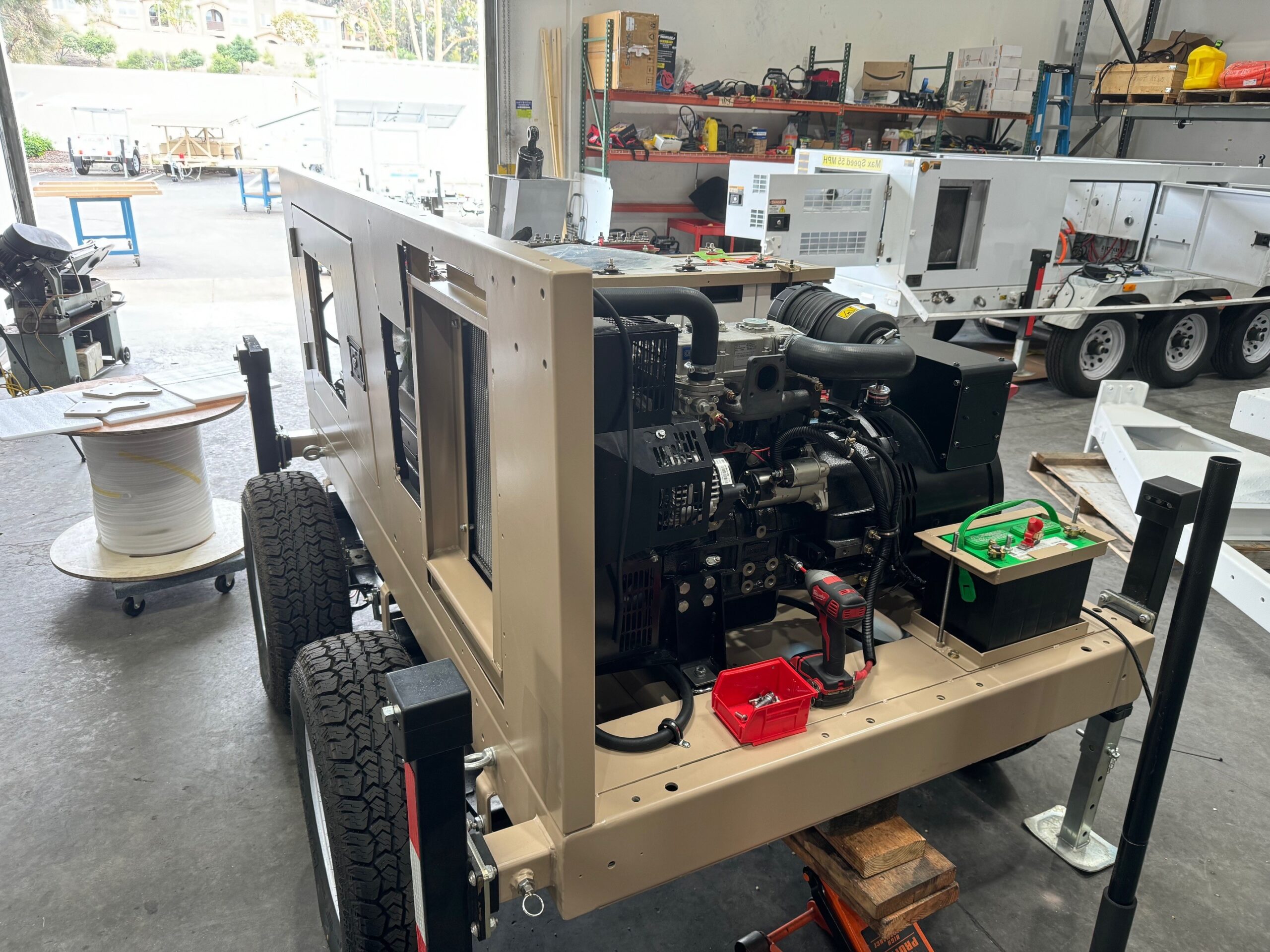 Open equipment compartment showing the diesel engine and electrical components inside the 123-STG-4