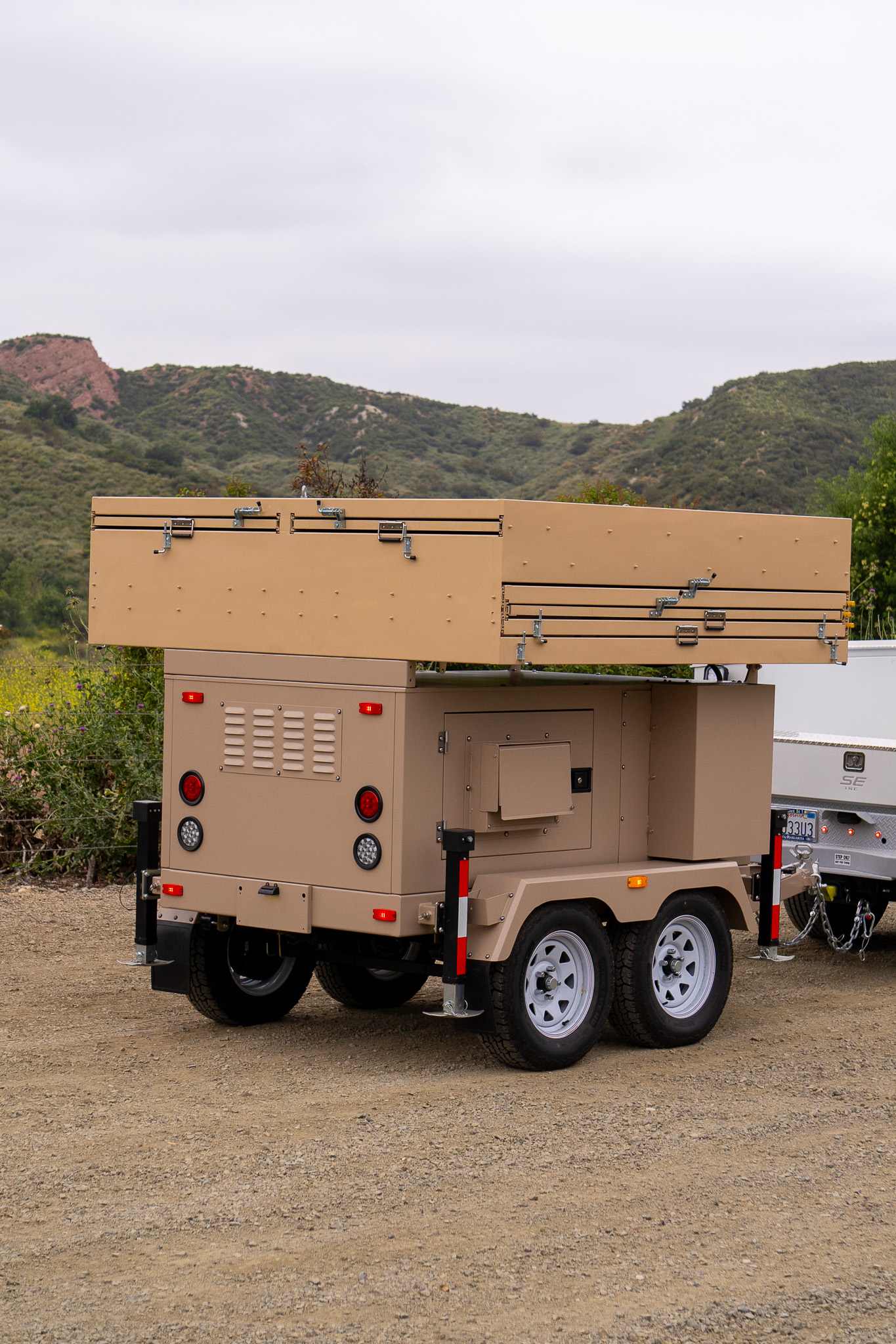 Rear view of a 123eSolar STG-4 trailer with its solar panels folded flat for towing