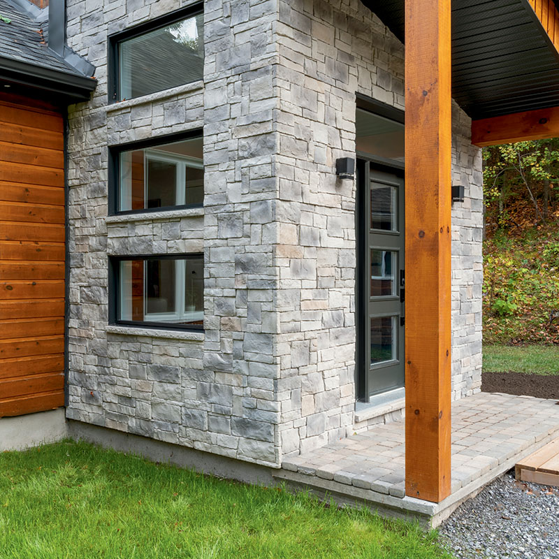 Exterior wall and entrance clad in light gray Be.On Stone Classic panels