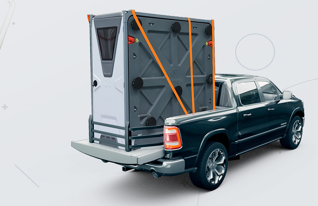 Folded CMAX CX20 shelter secured upright in the bed of a pickup truck