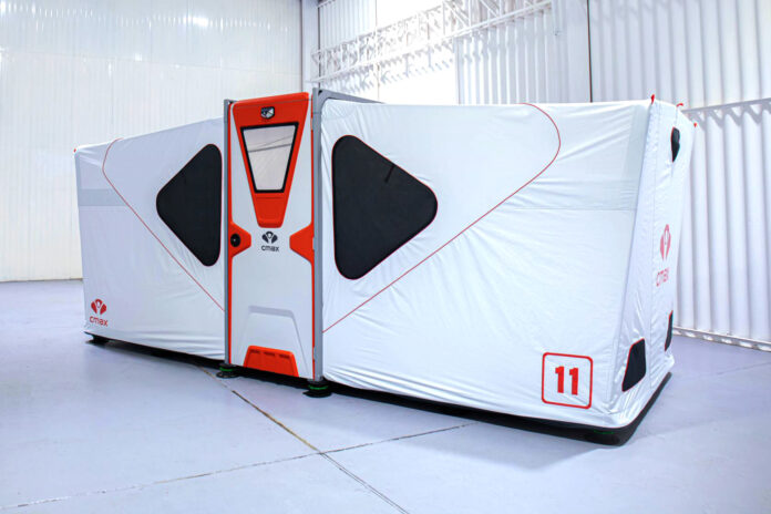 Fully deployed white and orange CMAX CX20 foldable shelter with raised floor and adjustable supporting feet