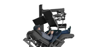 User working in a deeply reclined chair surrounded by the ErgoQuest Zero Gravity Workstation 2c