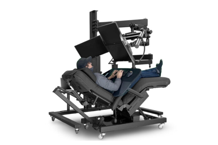User working in a deeply reclined chair surrounded by the ErgoQuest Zero Gravity Workstation 2c