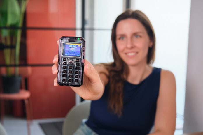 Person holding an assembled MAKERphone 2.0 DIY 4G mobile phone