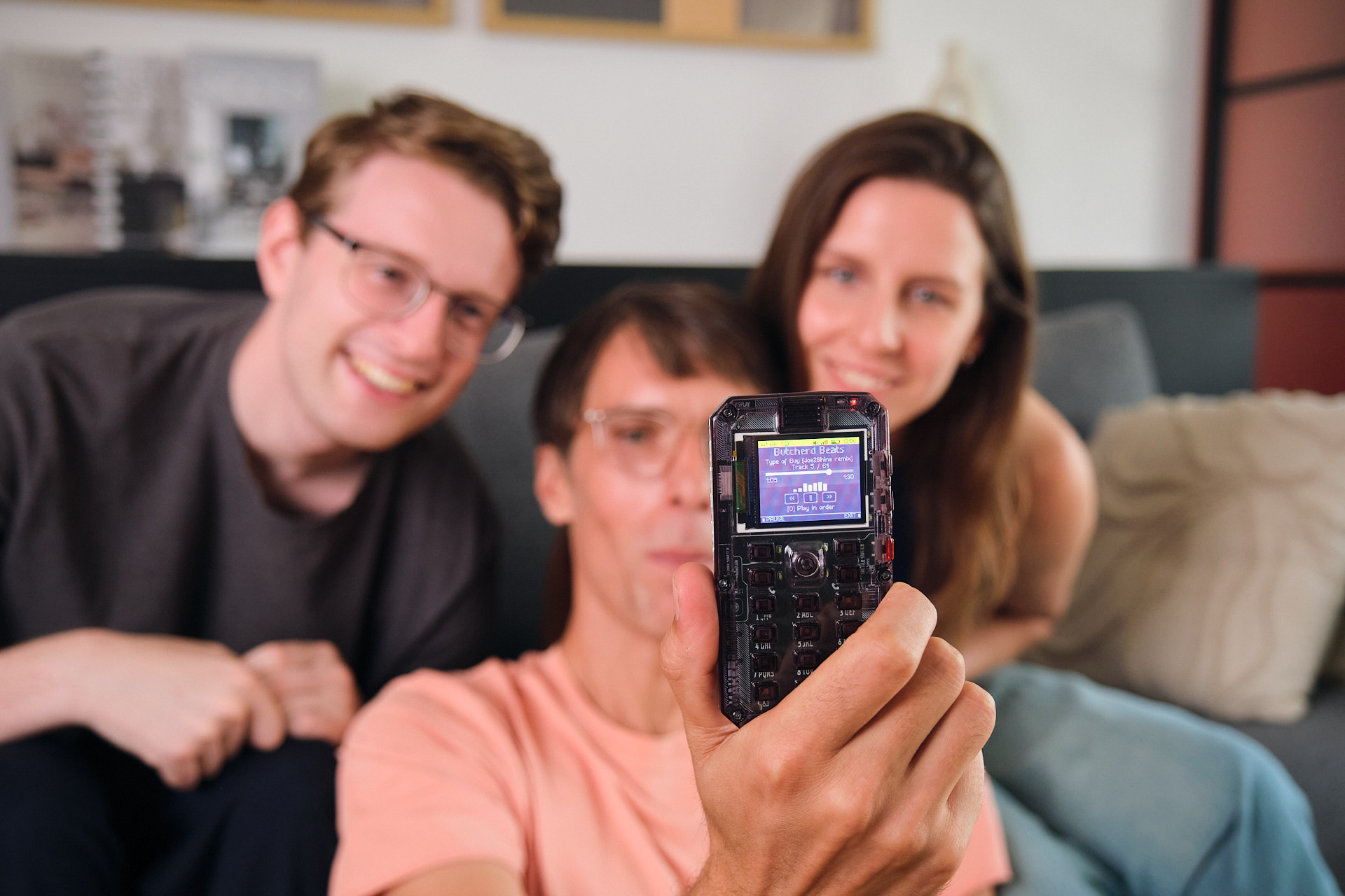Family displaying an assembled MAKERphone 2.0 with transparent casing