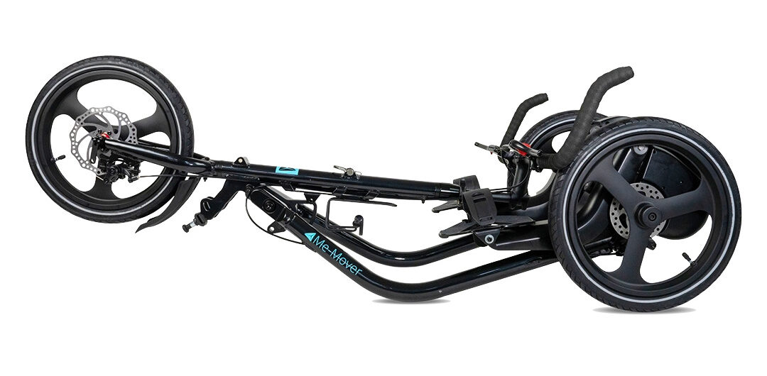 Black Me-Mover Speed Ultra folded flat with handlebars beside its three-wheel frame