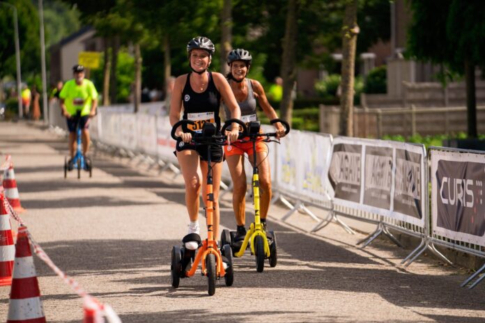 Riders using orange and yellow Me-Mover Speed Ultra outdoor fitness machines