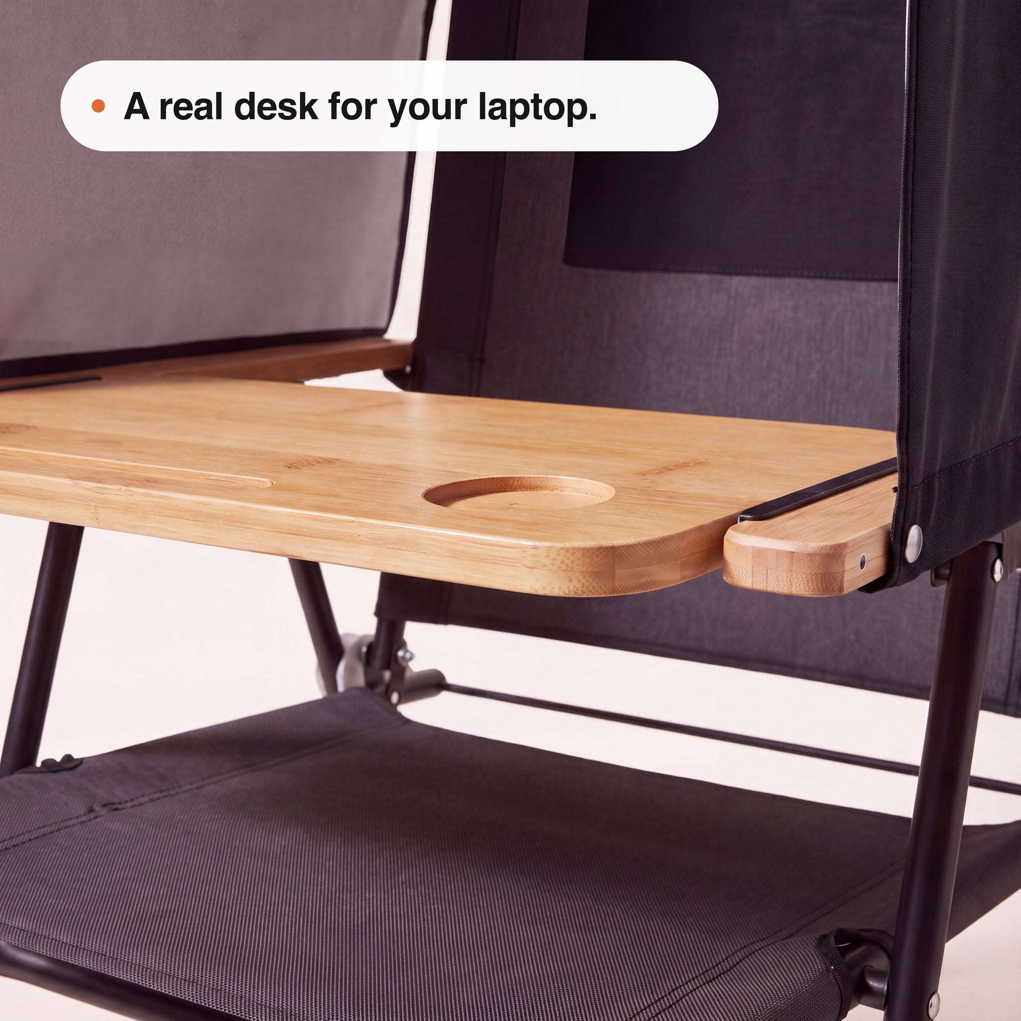 Close-up of the NomaPod wooden-look laptop desk and built-in cup recess