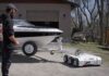 Parkit360 Carrier 13K electric dolly moving a boat trailer outside a garage