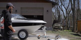 Parkit360 Carrier 13K electric dolly moving a boat trailer outside a garage