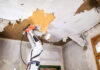 Worker using a ROKAMAT Chameleon to remove wallpaper from a ceiling