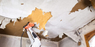Worker using a ROKAMAT Chameleon to remove wallpaper from a ceiling
