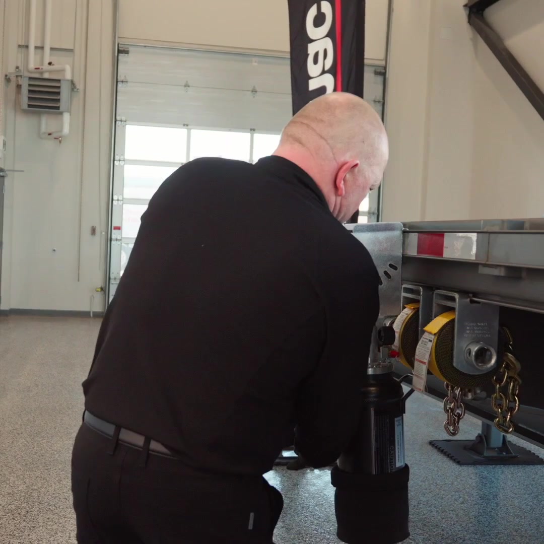 RigCraftor Pneumatic Strap Launcher standing beside a trailer during setup