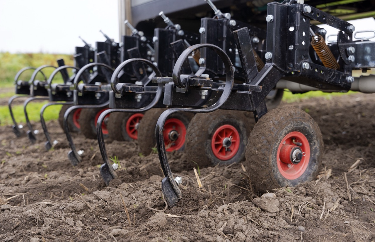 Close-up of Roboton Farmer mechanical weeding blades moving through soil