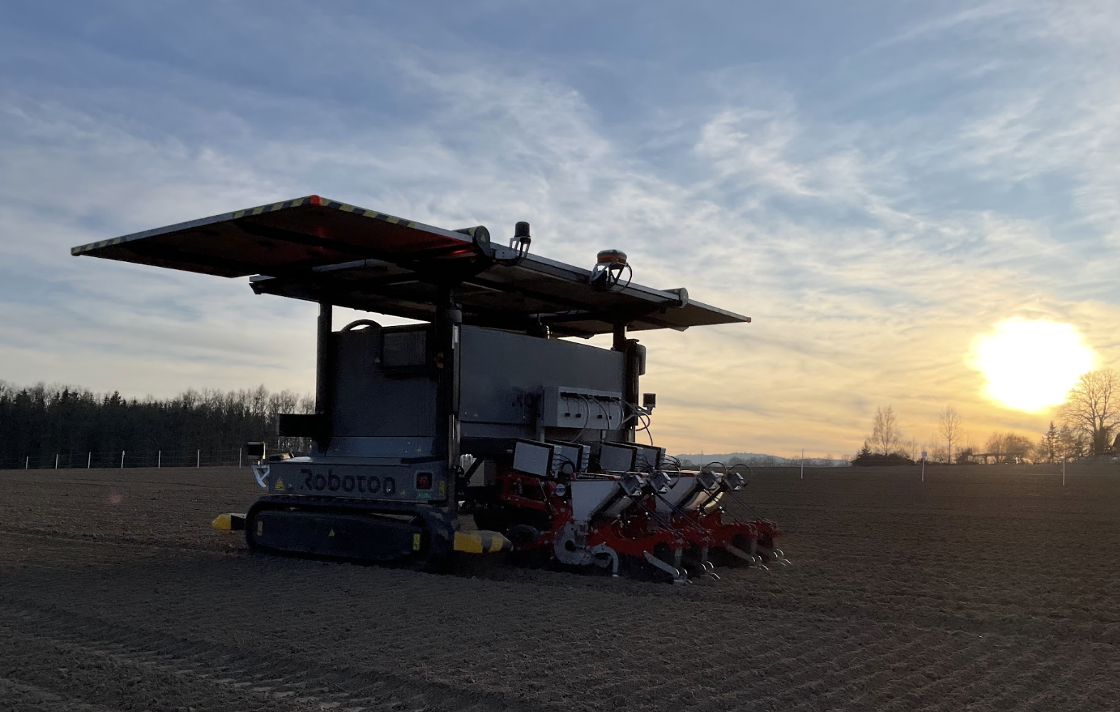 Roboton Farmer operating in a field with its precision sowing attachment