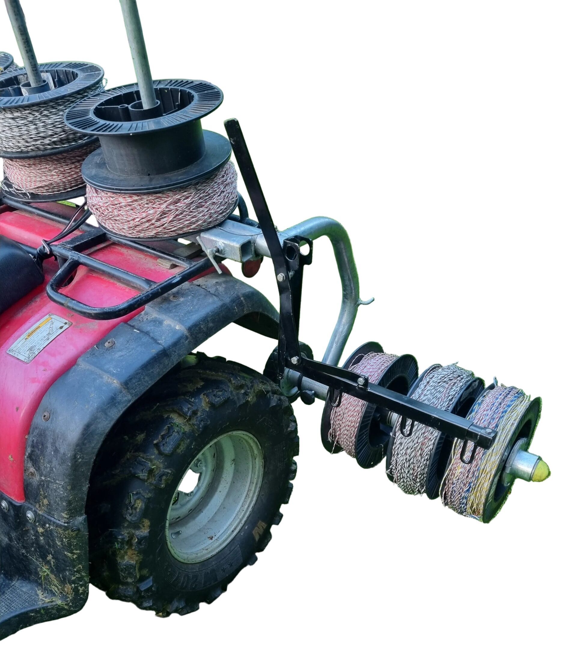 Sheep School three-reel winding mechanism positioned beside the rear wheel of an ATV