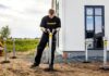 Installer positioning a galvanized StopDigging ground screw beside a modular building