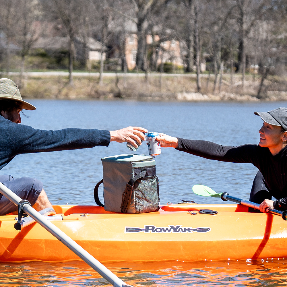 Two RowYak occupants sharing a drink while seated face to face