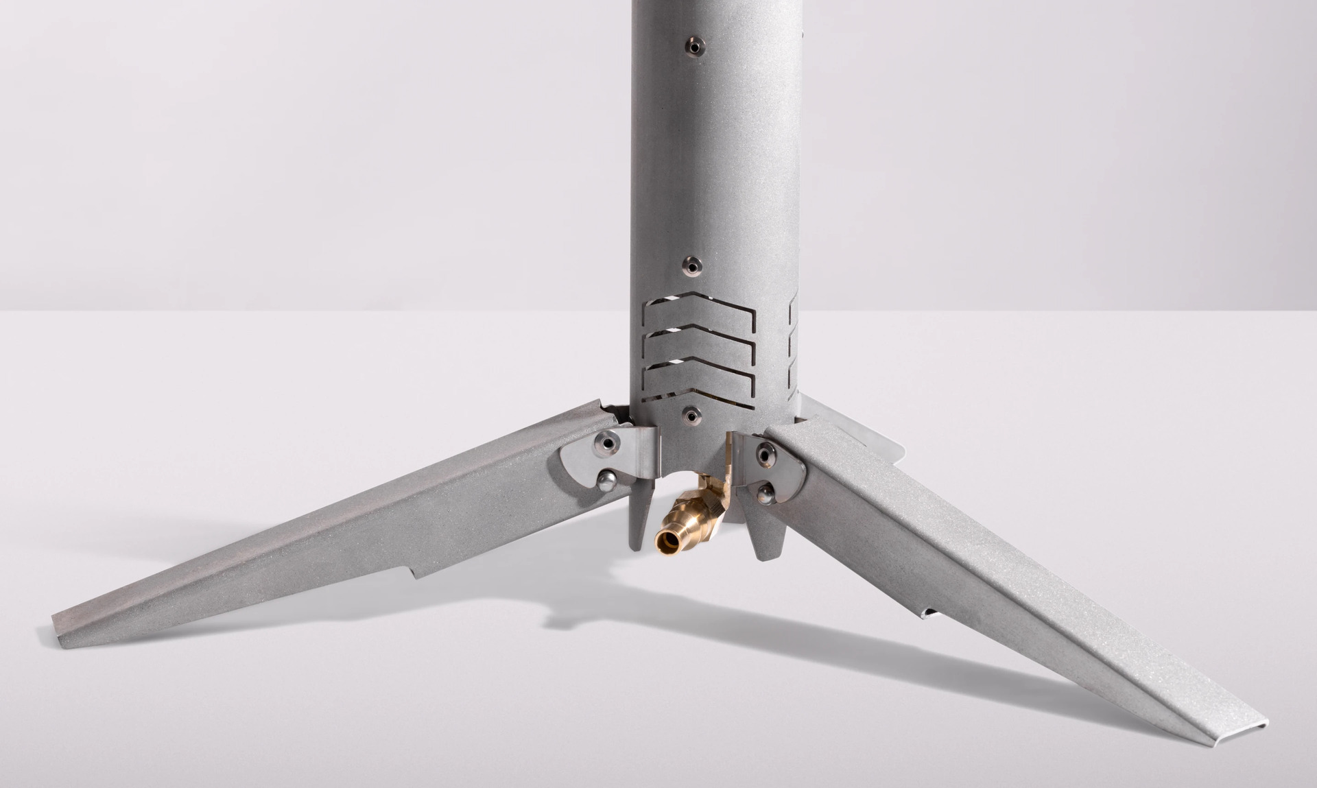 Folding stainless-steel support legs attached to the base of the Happy Caveman Campfire
