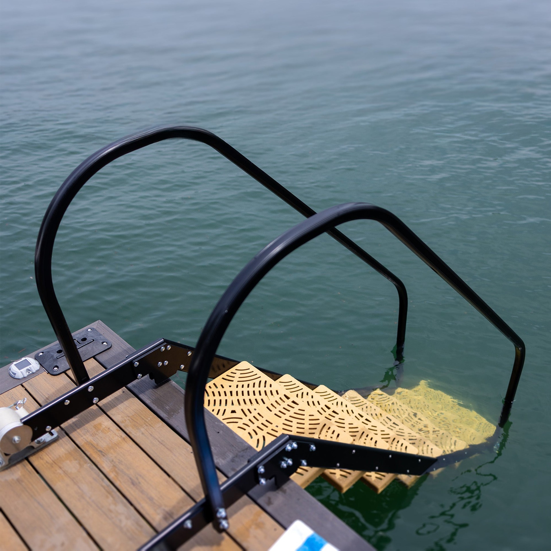 Close view of NautiSteps textured polypropylene steps extending into the water